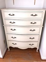 Front view of dresser showing four drawers and metal pulls