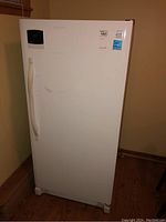 Front view of the white Kenmore upright freezer showing the handle and digital control panel