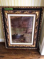 Full view of the framed painting showing the decorative wooden frame and the boats on water scene.