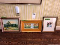 Three framed paintings shown side by side against a striped wallpaper with green measurement tags on each painting indicating their sizes: 8x10, 4x10, and 4x4.
