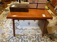 Front view of rectangular wood table showing top and tapered legs