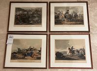 Four framed hand-colored engravings depicting different scenes from the Battle of Waterloo arranged in two rows of two