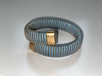Bracelet coiled showing wrap profile and gold beaded accents