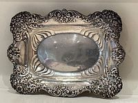 Top view of ornate sterling silver tray showing overall design and central cartouche