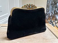 Front view showing black velvet body and decorative clasp