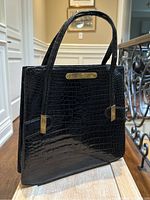 Front view showing crocodile embossing, brass nameplate and overall shape