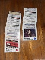 Photo showing the full set of 24 records laid out on a wooden floor, displaying the collection size and condition of the sleeves.