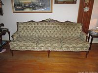 Full view of the vintage 3-seat couch showing floral upholstery and wooden frame.