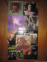 Photo showing nine jazz vinyl records stacked closely, featuring Herb Alpert prominently and other jazz artists