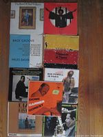 Photo showing the 9 jazz vinyl records laid out on wooden floor including titles like The Best of Red Williams, Bags' Groove, Dizzy Gillespie, Miles Davis, Bud Powell, Dexter Gordon and others.