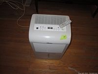 Danby Premiere dehumidifier from an angled top view showing the control panel, vents, and remote control on top.