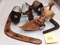 Photo showing all items in the lot including the Annalee mouse figurine in the wooden boat, wooden vase, two stereoscope viewers, painted wooden boomerang, and wooden pipe-shaped object.
