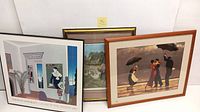 Lot showing all three framed art prints together including the Thomas McKnight poster and two other prints