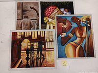 Four oil paintings displayed together showing the range of art styles and subjects in the lot
