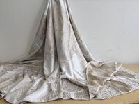 Full view of the tablecloth draped to show fabric length, texture, and design details on lighter-colored side