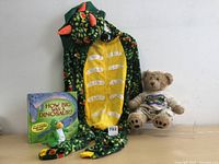 Full lot including dinosaur onesie pajamas, teddy bear plush, dinosaur toy, and children's book