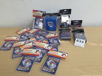 Photo showing 15 loose new Pokémon trading cards, 4 packs of Neo sleeves and blue card holder box