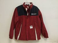 Front view of red and navy blue Canada youth winter jacket size 14/16.