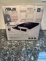 Front box of Asus External Slim DVD-RW SDRW-08D2S-U showing product image and compatibility logos for Windows and Mac.