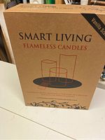 Front of the box showing the brand Smart Living Flameless Candles with vanilla scent