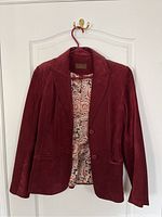 Red suede leather blazer-style ladies jacket by Danier, showing front, button closure, and patterned interior lining.