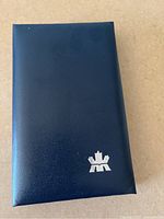 Navy blue presentation case with Royal Canadian Mint logo on top.