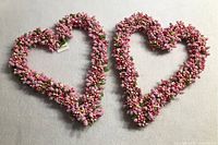 Two new heart-shaped wreaths made of small artificial pink and multicolored berries