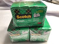 Three green sealed packs of Scotch Magic Tape stacked, each pack contains 4 rolls.