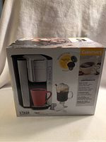 Box of new Cuisinart compact single serve coffeemaker with product images and brand name visible.