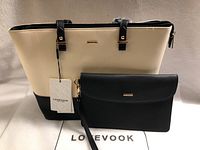 Handbag and clutch in set displayed on white surface with visible Lovevook tag and brand name mat beneath.