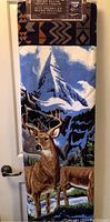 Photo of the folded throw blanket showing detailed deer scene with mountains.