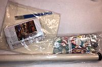 Both paint by numbers kits packed in plastic, including brushes, numbered paint pots, and rolled canvas in protective tube.