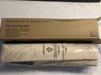 Pet heating mat in original packaging, rolled and wrapped in plastic.