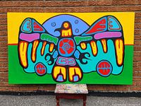 Full front view of the stretched, framed painting displayed against a brick wall with a small stool below.