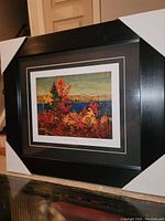 Overview of framed print showing black wood frame, glass and double mat