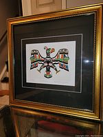 Full framed fine art print with visible gold decorative frame and matting, showing the Thunderbird artwork in full view.