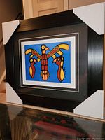 Framed fine art print with protective corner covers, showing full artwork and frame detail.