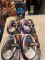 Five Star Trek action figures in original packaging displayed on table