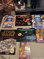 Top view of 6 Star Wars books laid out on floor, two sealed, five with covers visible.