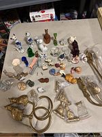 Overview of entire cat figurine and decor collection displayed on table showing multiple materials and colors