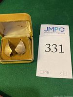 Front angle view showing both gold earrings with etched kite shapes in their velvet box showing 14KT GOLD marking inside the lid.