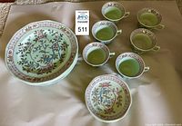 Set of 5 lunch plates, 6 tea cups, and 6 matching saucers in pale green calyx ware with floral and bird decoration