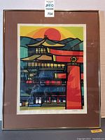 Full frontal view of framed woodblock print showing mat, frame, and overall artwork.