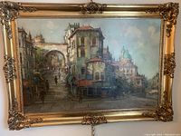 Full view of framed oil painting showing city scene with arch and stairs