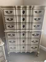 Front view of cream-painted French Provincial tall dresser showing six drawers and metal hardware