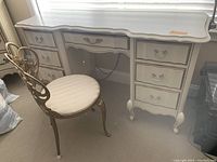 Front view of vanity desk with chair showing overall design and condition