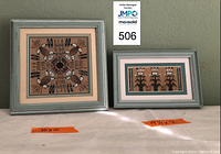 Two framed Navajo sandpaintings side by side, one 10x10 and one 9.5x7, showing water creature and corn people with rainbow bars motifs