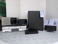 Full lot displayed showing Onkyo LS3100 system components, Panasonic clock radio, and VHS player.