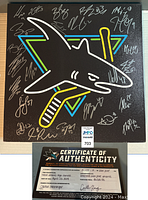 Front of 16 x 16 inch canvas showing neon-style Sharks logo and player signatures, certificate of authenticity included