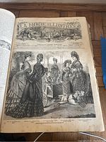 Open page showing detailed black and white illustration of women in Victorian dresses with dog, titled La Mode Illustrée journal